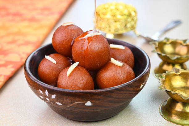 Gulab Jamun popular Indian dessert in a wooden bowl.