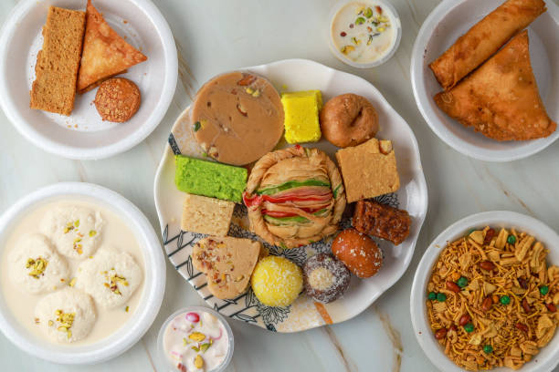 Above view of  Indian assorted sweets  and mithai on a marble background.